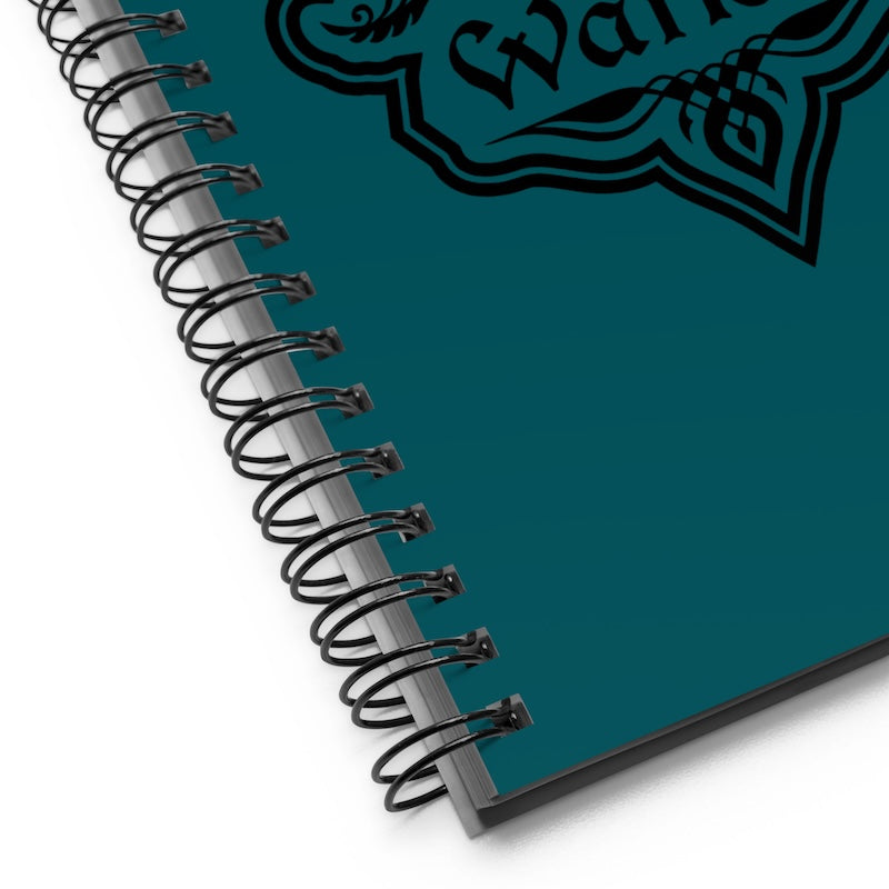 Teal notebook with spiral binding on a white background