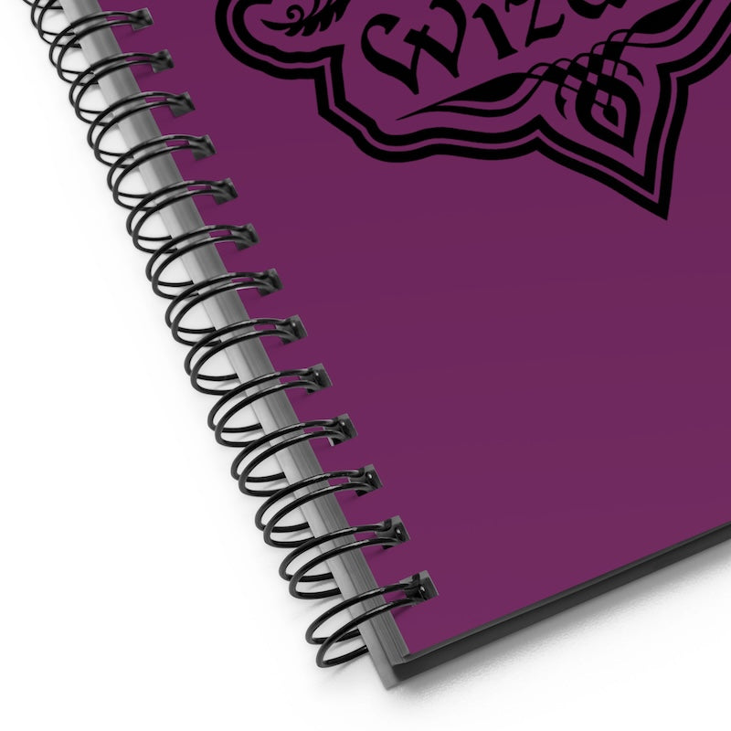 Purple notebook with a decorative logo on a white background