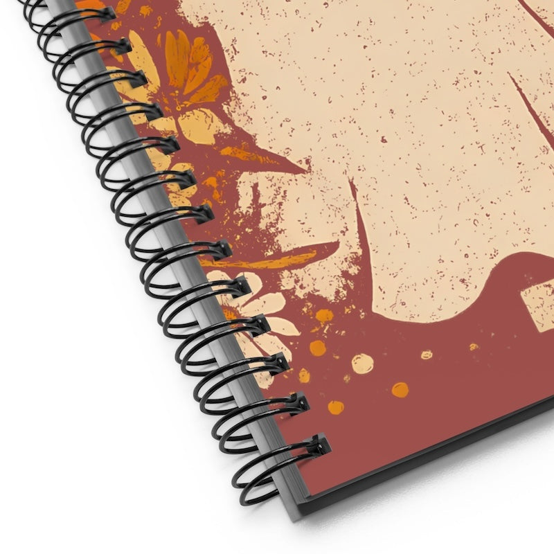 Spiral-bound notebook with floral design on beige background