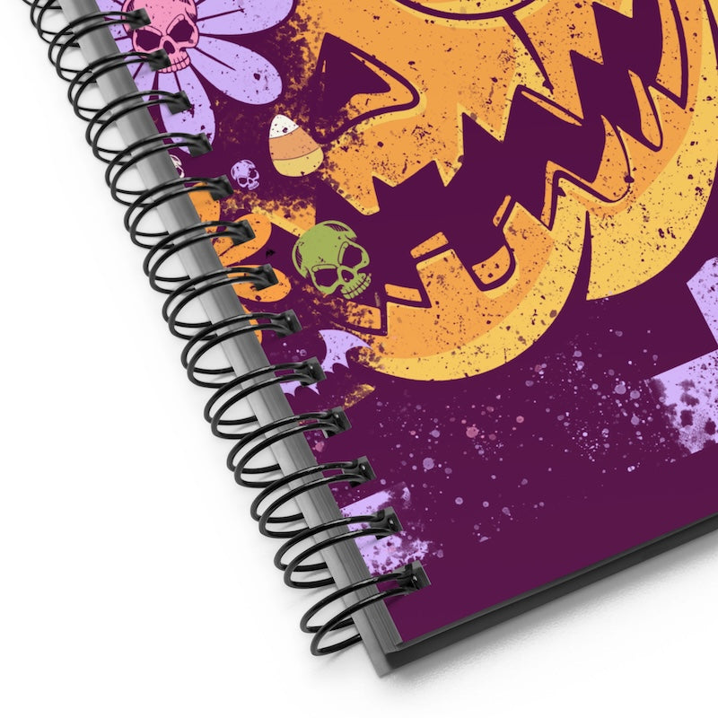 Spiral-bound notebook with Halloween-themed design on a purple background