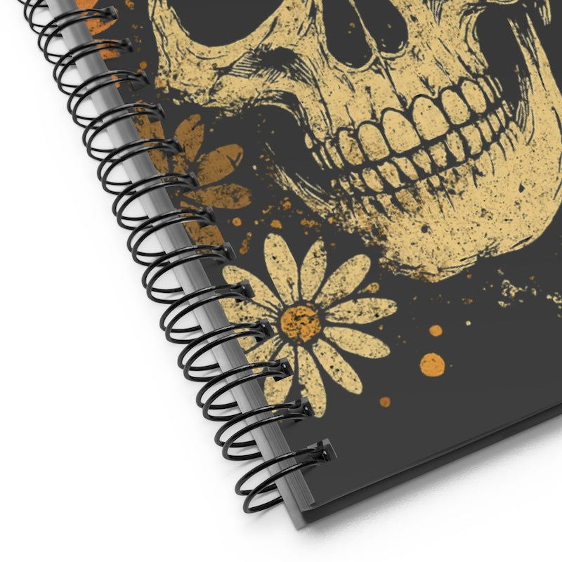 Notebook with skull and flower design on a black background