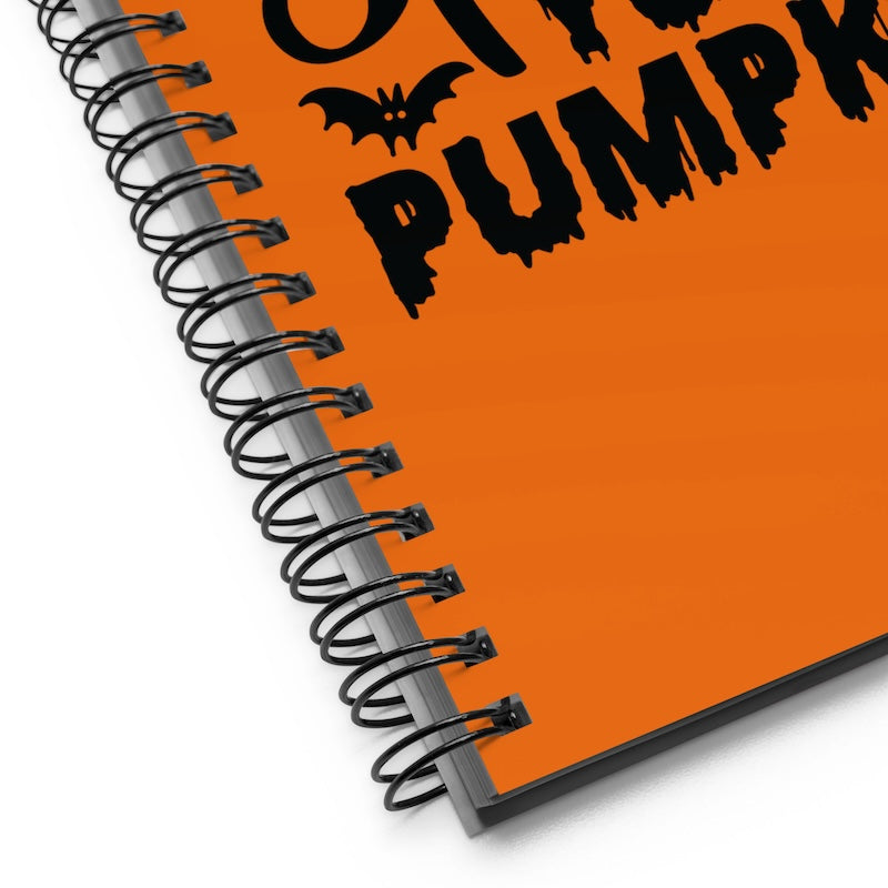 Spiral-bound notebook with Halloween design on an orange background