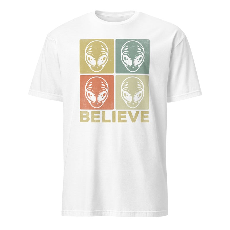 White t-shirt with alien head graphic and 'BELIEVE' text on a white background
