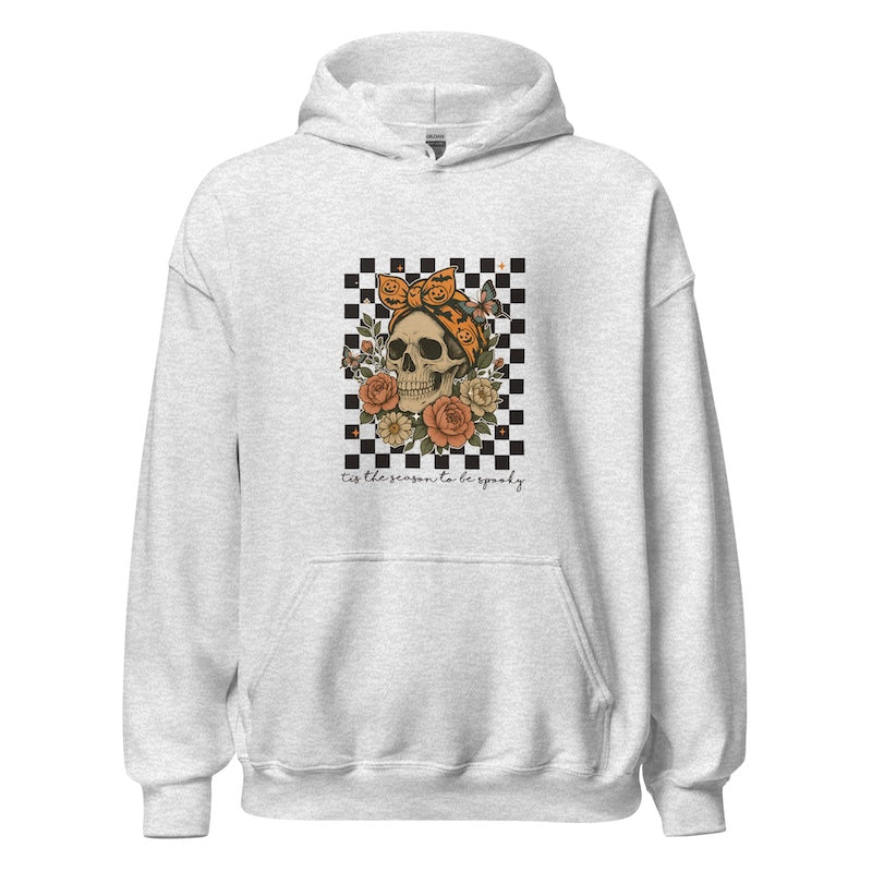 White hoodie with a skull and floral design on a checkered background