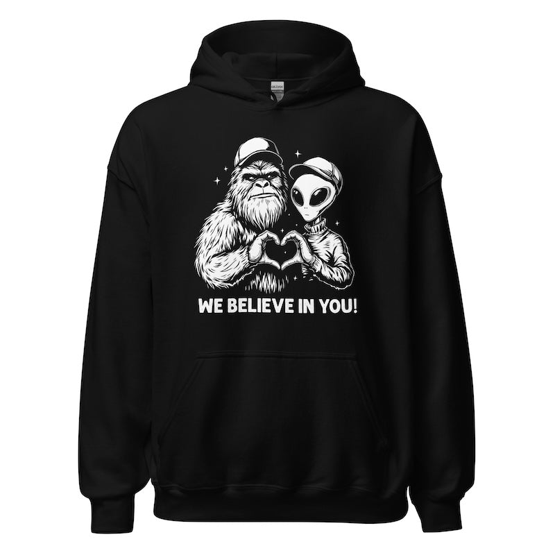 Black hoodie with alien and creature design and 'We Believe In You!' text on a white background