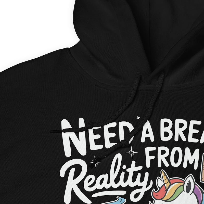 Black hoodie with 'Need a Break from Reality' text and unicorn graphic.