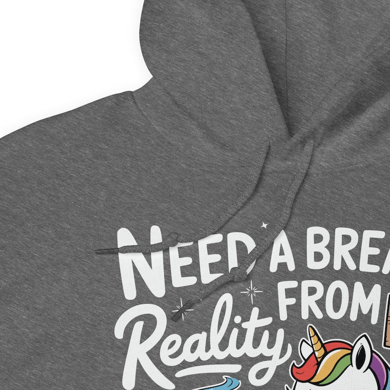 Gray hoodie with text 'NEED A BREAK FROM Reality' and a unicorn graphic.