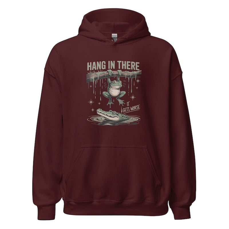 Maroon hoodie with graphic design of a frog and alligator and text 'Hang in there, I get it, I get worse' on a white background.