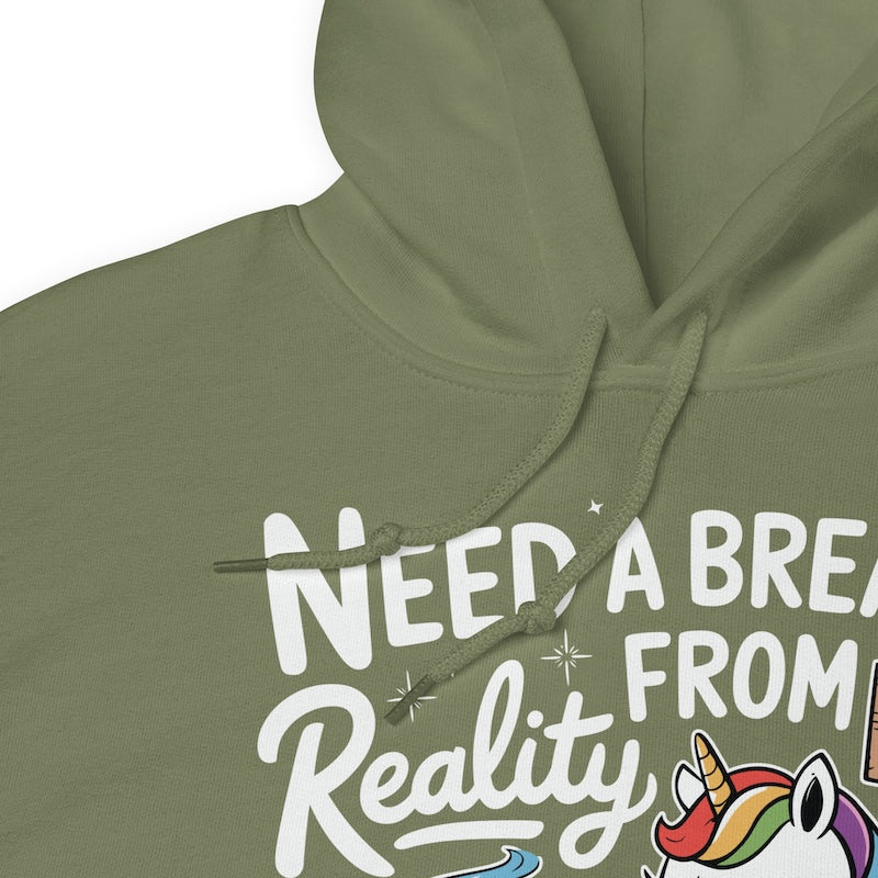 Green hoodie with text 'NEED A BREAK FROM Reality' and a unicorn graphic on a white background