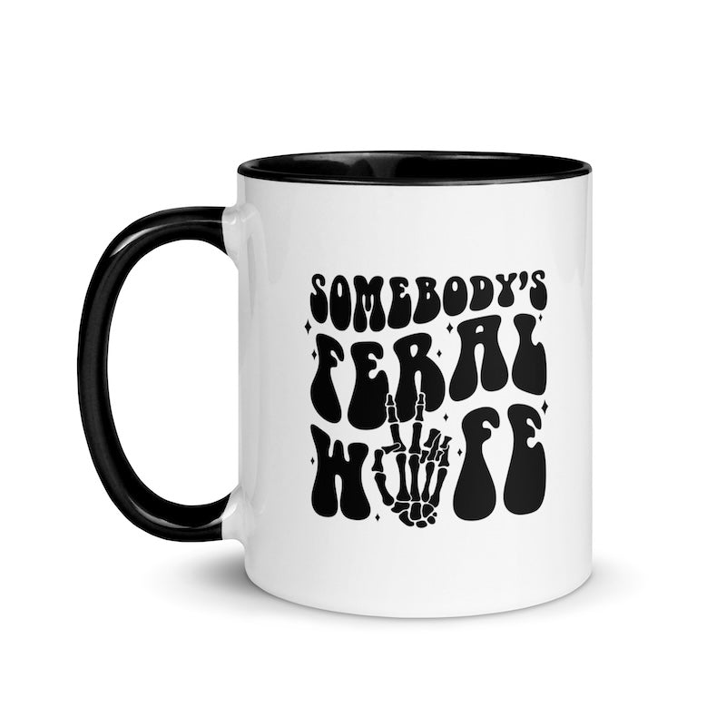 White mug with black interior and handle, featuring text and skeleton hand design.