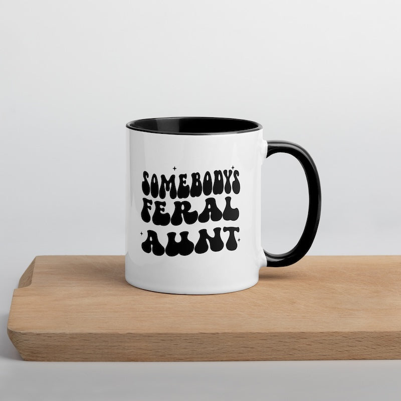 White mug with black interior and handle, featuring text on a light gray background