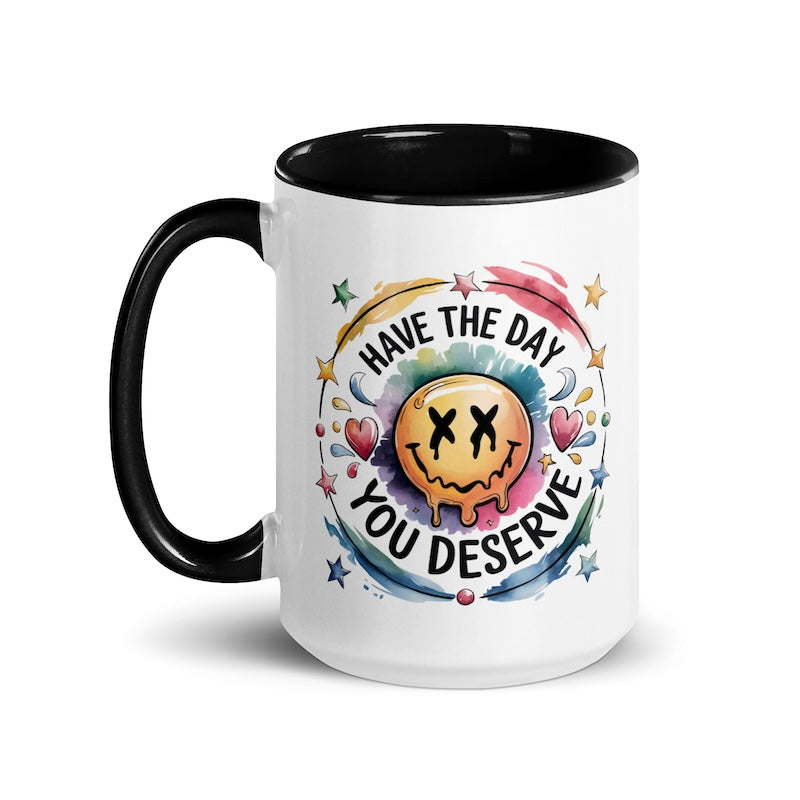 Mug with smiley face design and motivational text on a white background