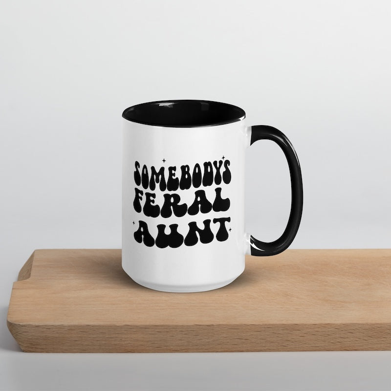 White mug with black text on a wooden surface