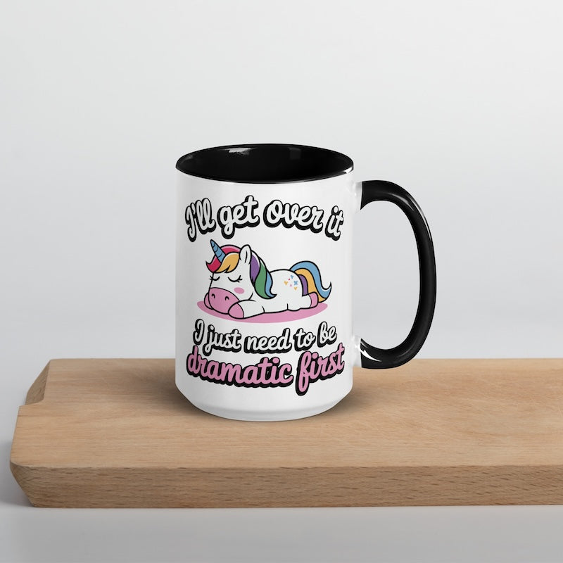 Mug with unicorn design and humorous text on a wooden surface
