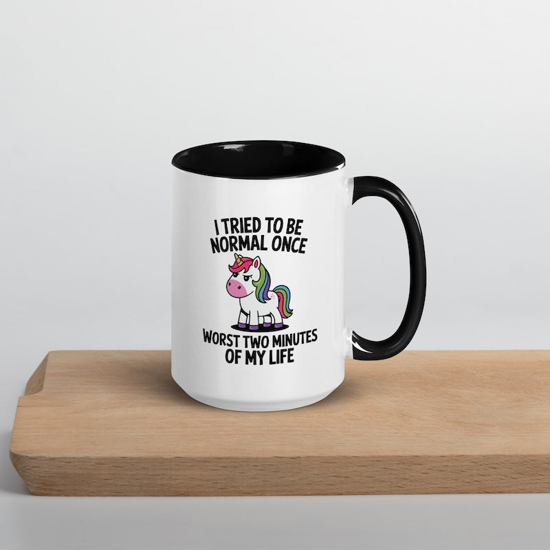 Mug with unicorn graphic and humorous text on a wooden surface
