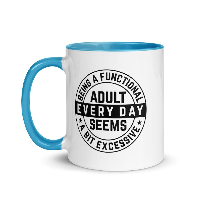White mug with blue handle and interior, featuring a black circular design with text on a white background.