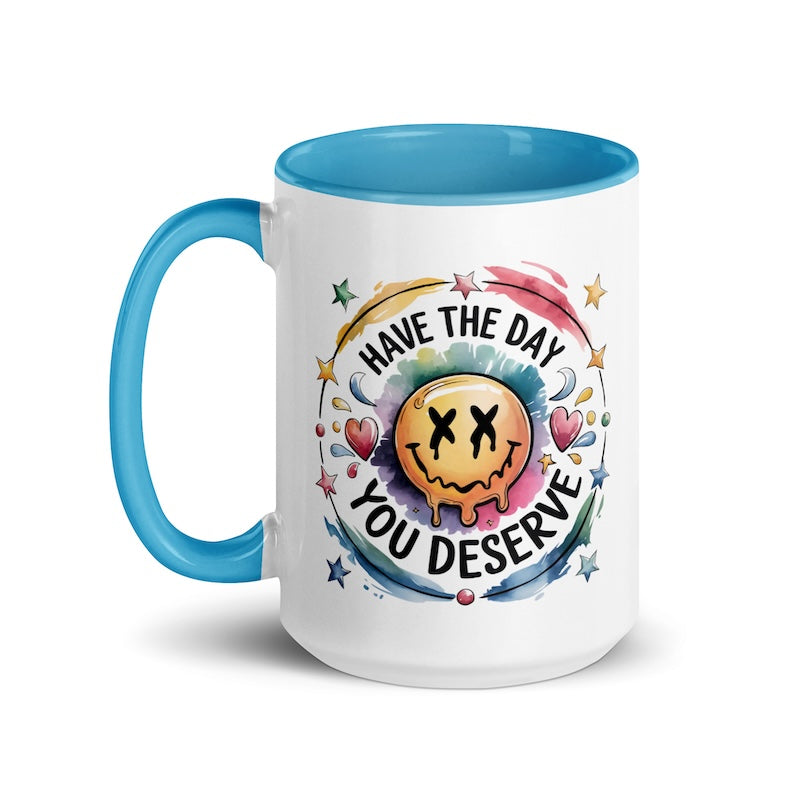 Mug with smiley face design and motivational text on a white background