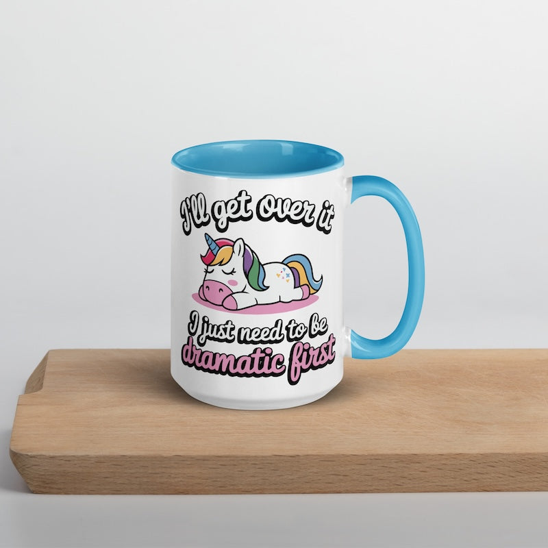 Mug with unicorn design and humorous text on a wooden surface