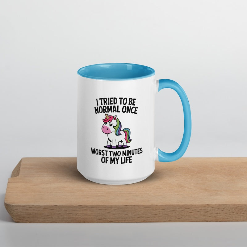 Mug with unicorn graphic and text on a wooden surface