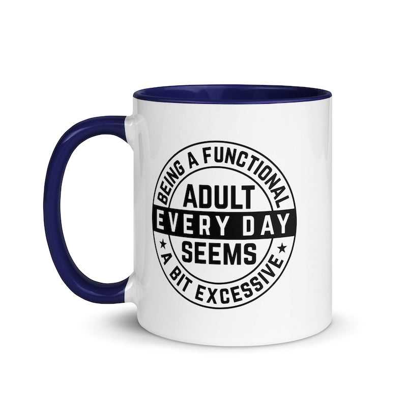 White mug with blue handle and interior, featuring a black circular design with text.