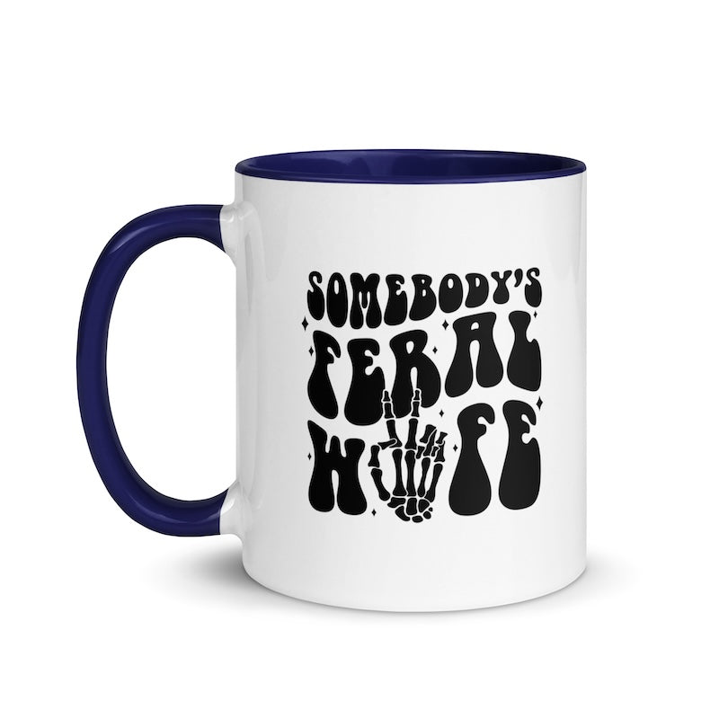 White mug with blue handle and interior, featuring black text and skeleton hand design.