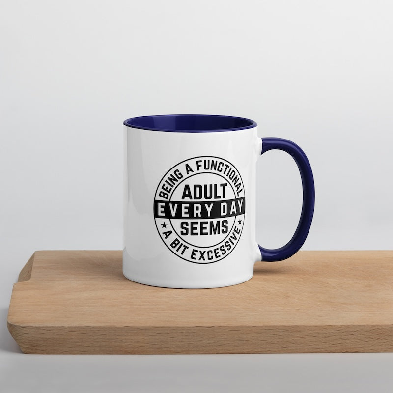 Mug with blue interior and handle on a wooden surface with a light gray background