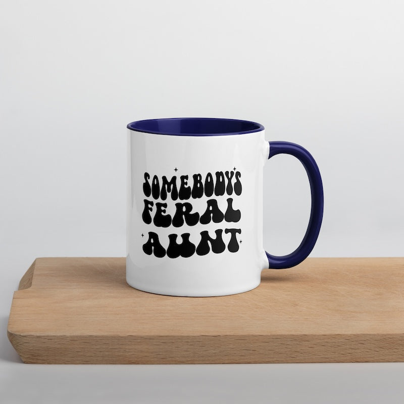 White mug with blue interior and handle, featuring black text on a light gray background.