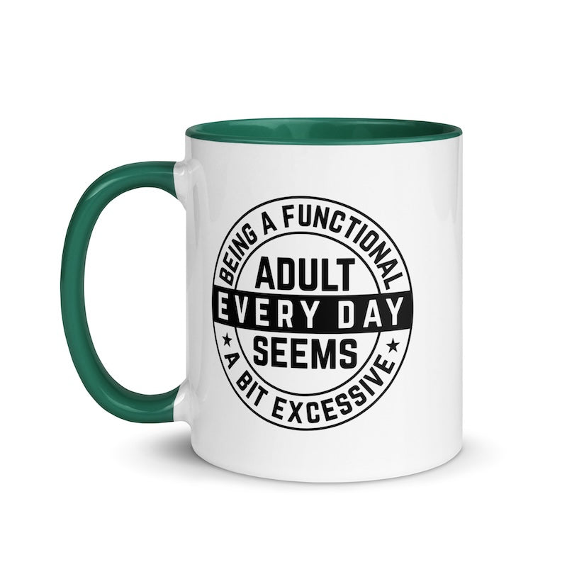 White mug with green handle and black text on a white background