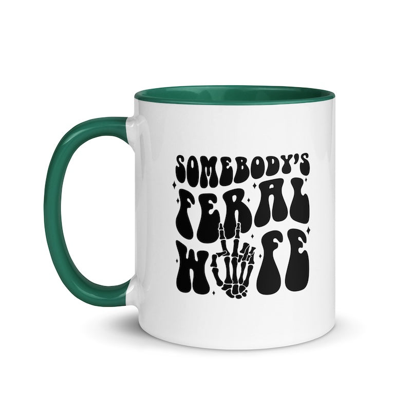 White mug with green handle and black text on a white background