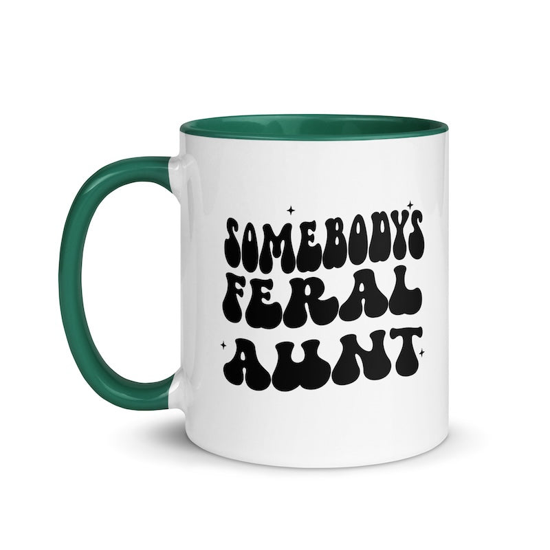 White mug with green handle and black text on a white background
