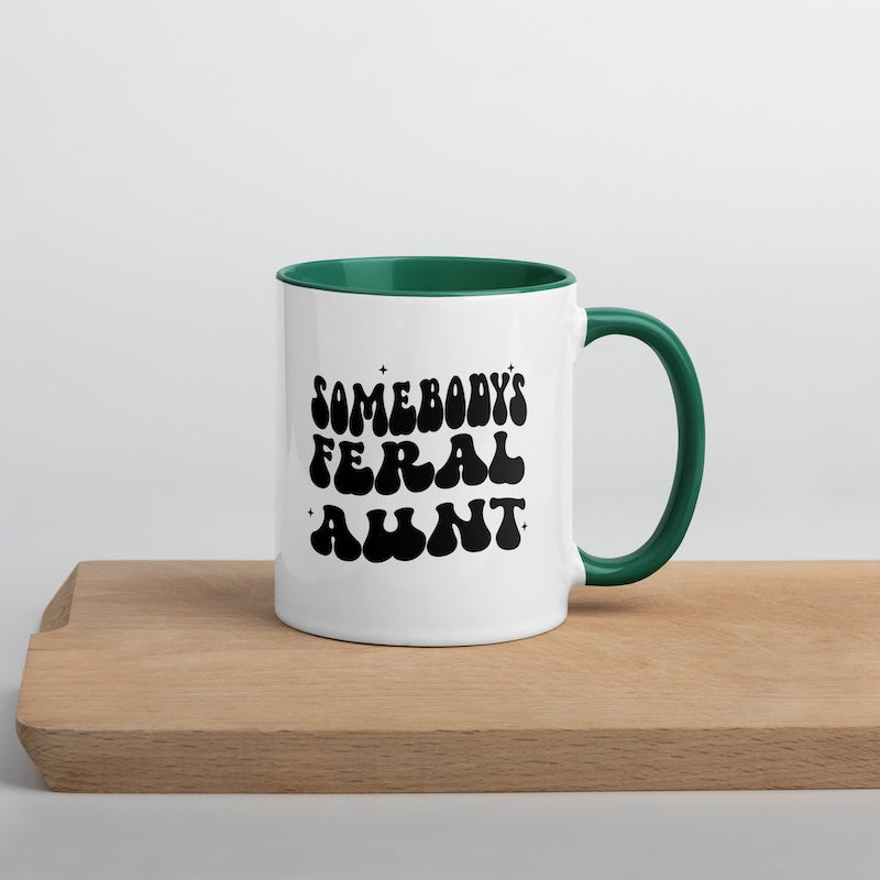 White mug with green interior and handle, featuring black text on a light gray background.