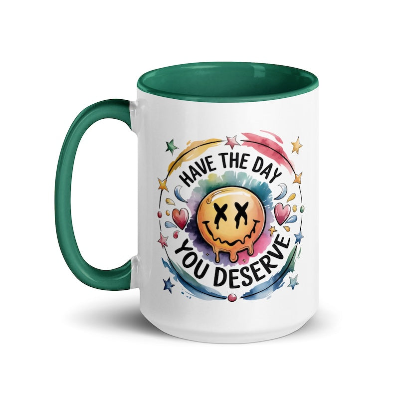 Mug with a smiley face design and text 'Have the day you deserve' on a white background