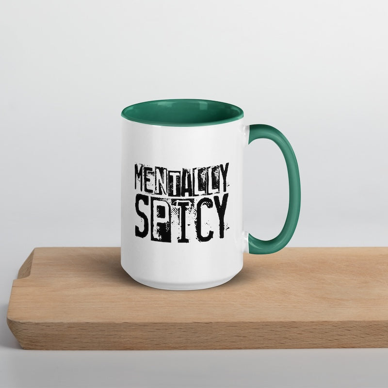 Mug with 'Mentally Spicy' text on a wooden surface