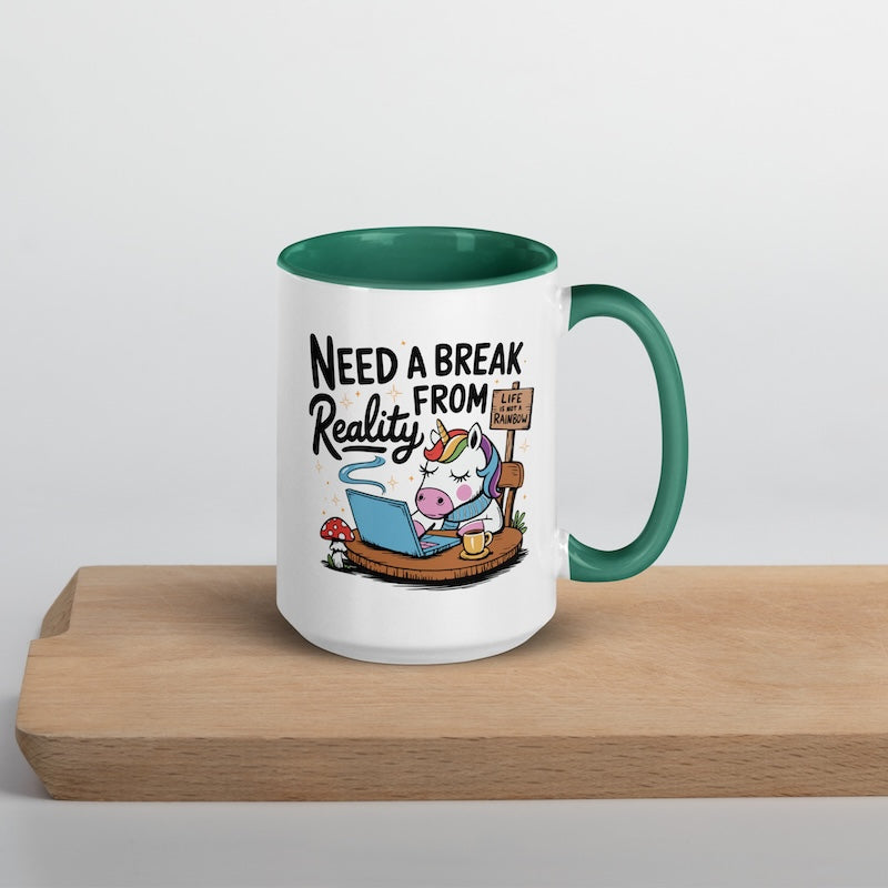 Mug with cartoon unicorn and text 'Need a Break from Reality' on a wooden surface.