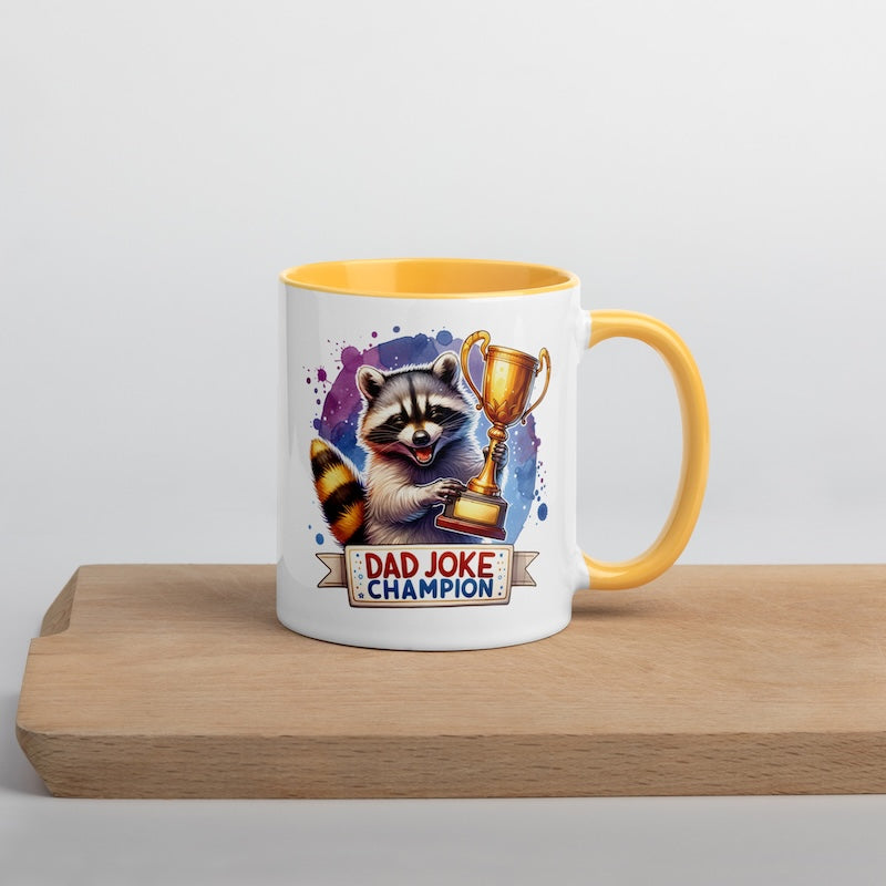 Mug with raccoon holding a trophy and 'Dad Joke Champion' text on a wooden surface.