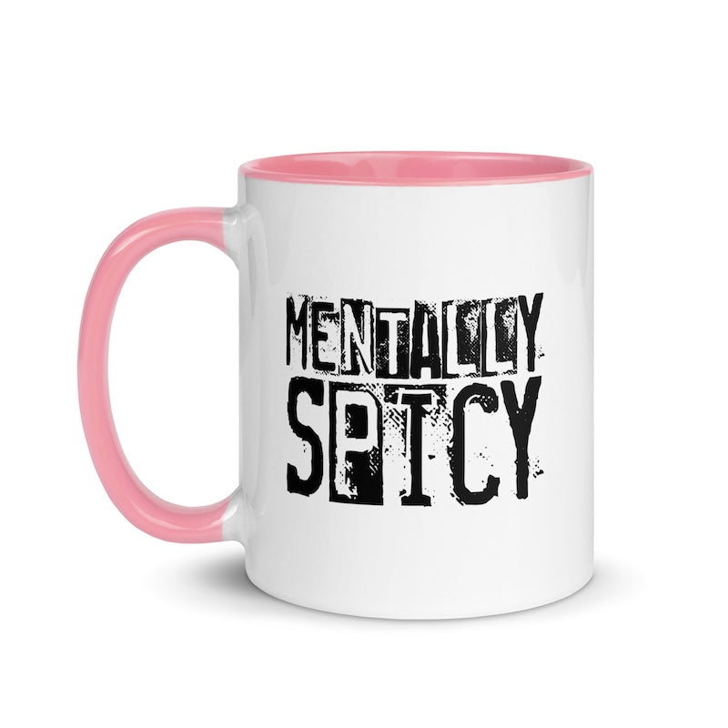 White mug with pink handle and interior, featuring the text 'MENTALITY SPICY' in black.
