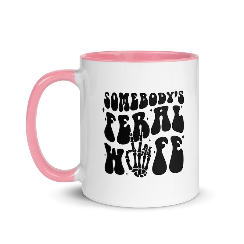White mug with pink handle and interior, featuring black text and skeleton hand design.