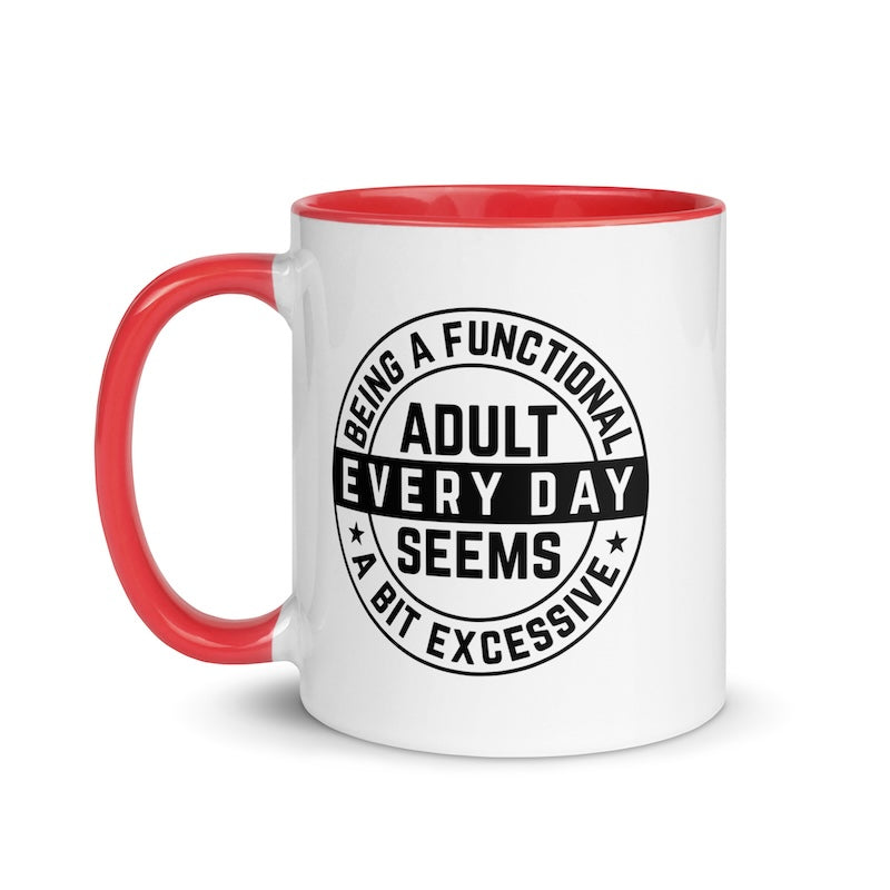 White mug with red handle and black text on a white background