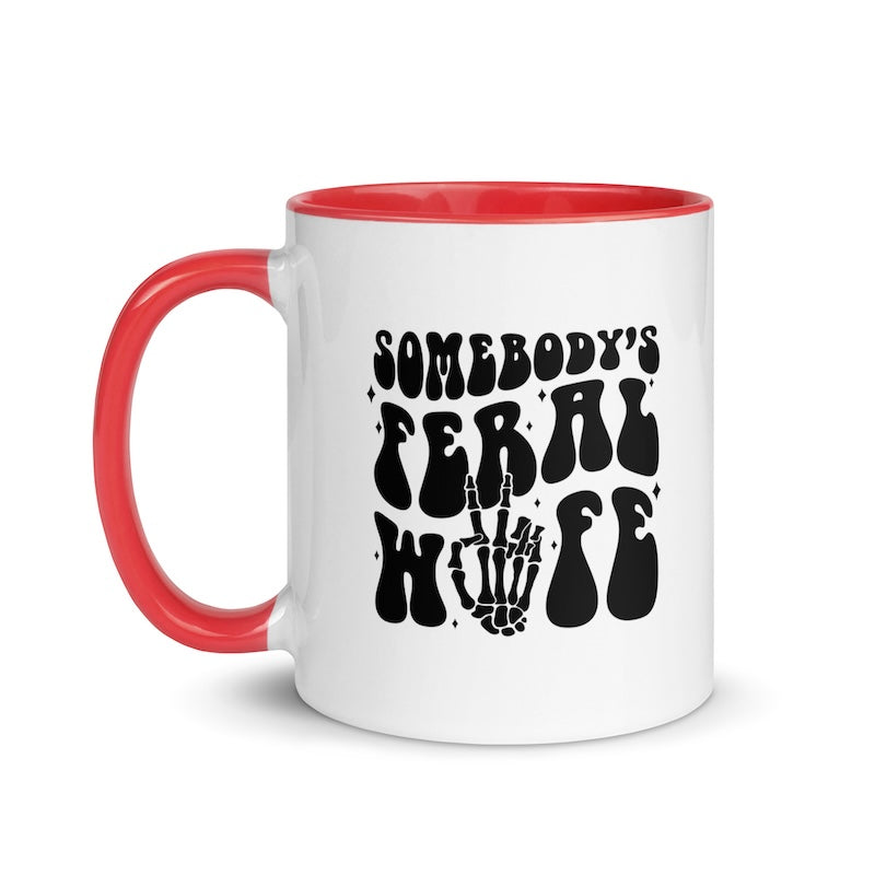 White mug with red handle featuring black text and skeleton hand design on a white background