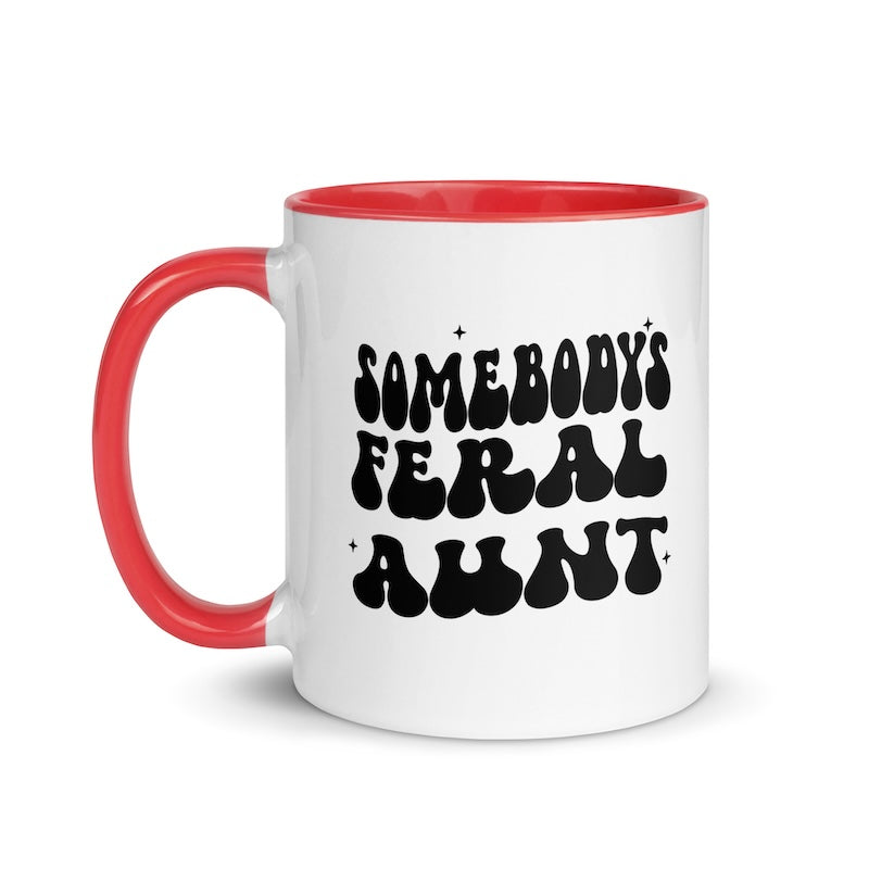 White mug with red handle and black text on a white background