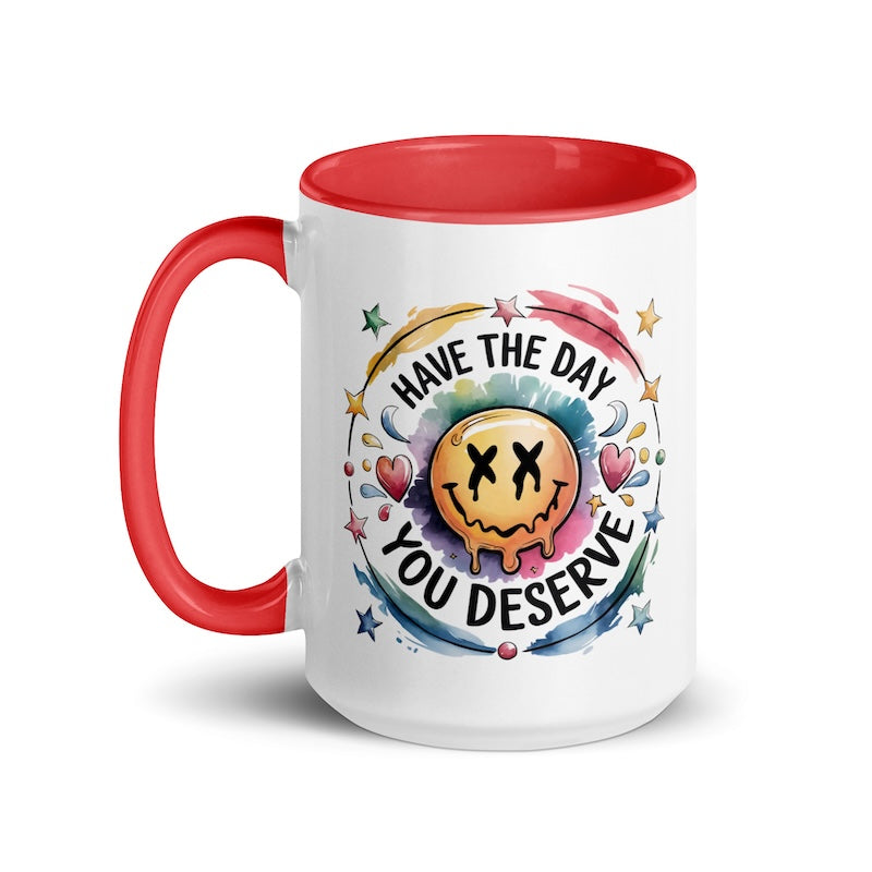 Mug with red interior and handle, featuring a smiley face and motivational text on a white background.