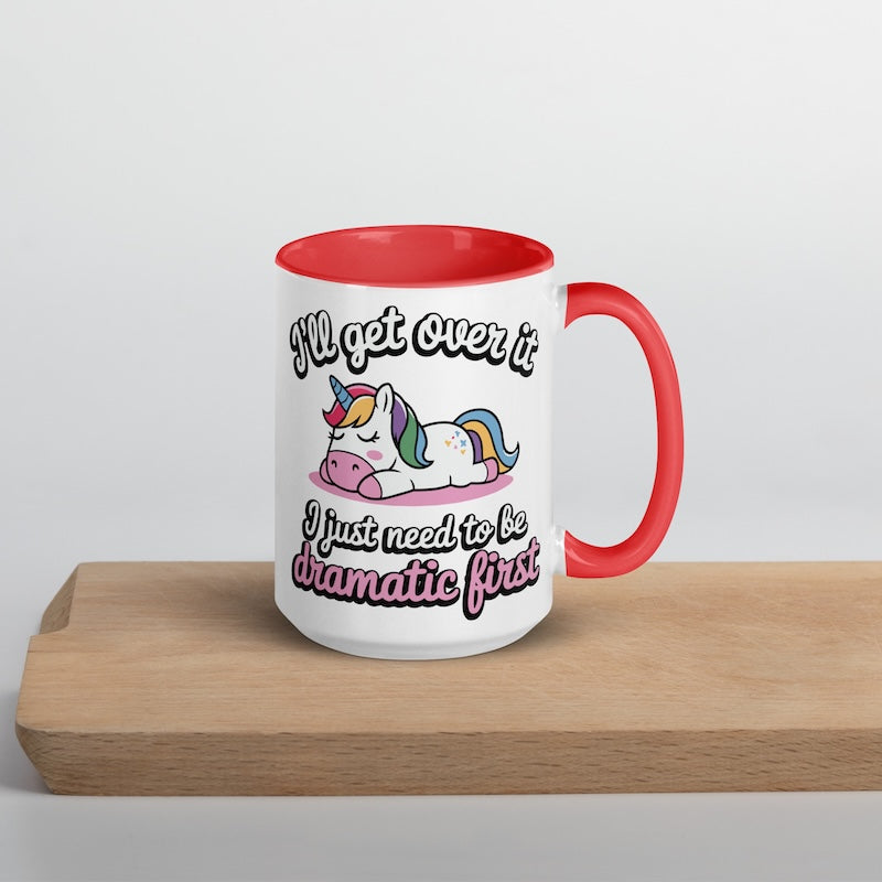 Mug with unicorn design and humorous text on a wooden surface