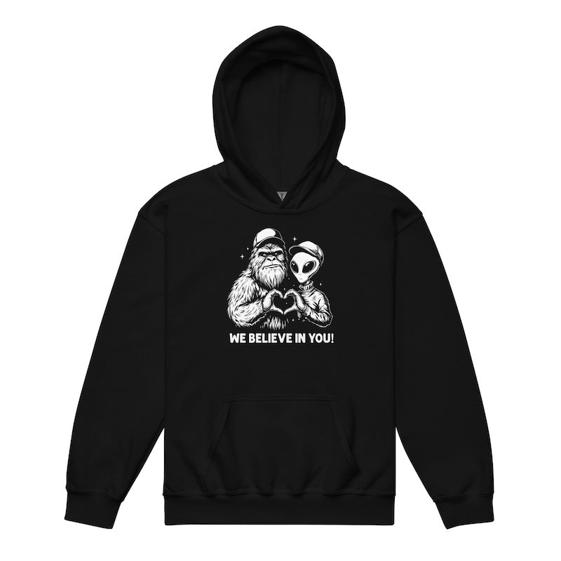 Black hoodie with a graphic of a man and alien holding hands and 'We Believe In You!' text on a white background.