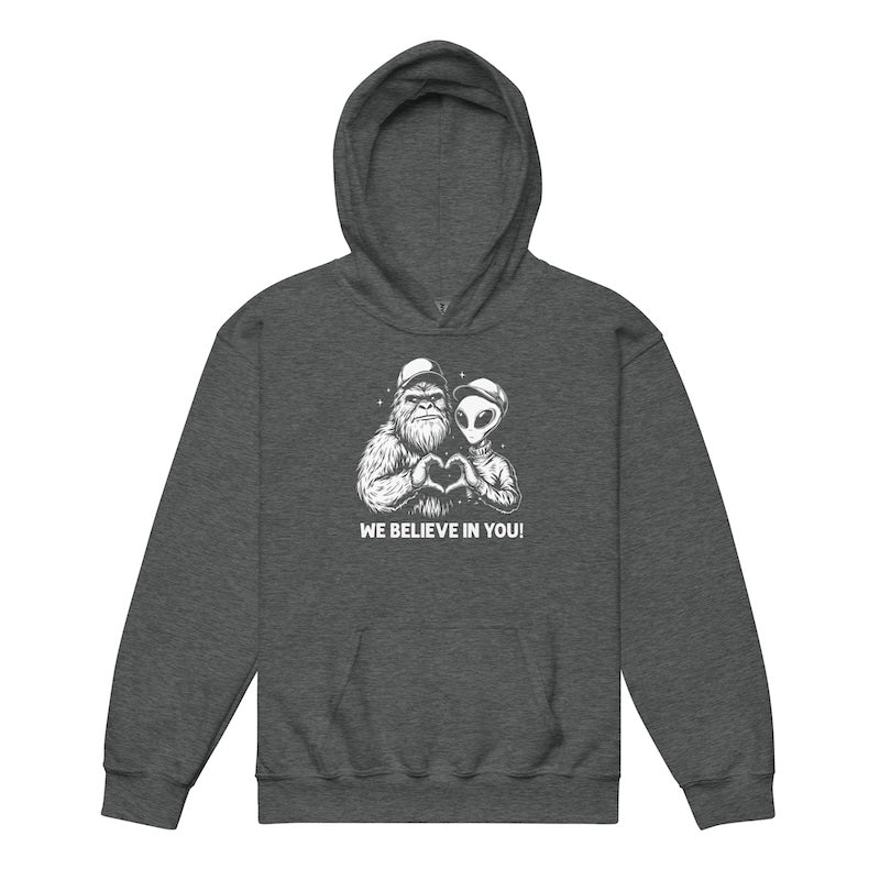 Gray hoodie with a graphic of a creature holding hands with a skull and 'We Believe In You!' text on a white background