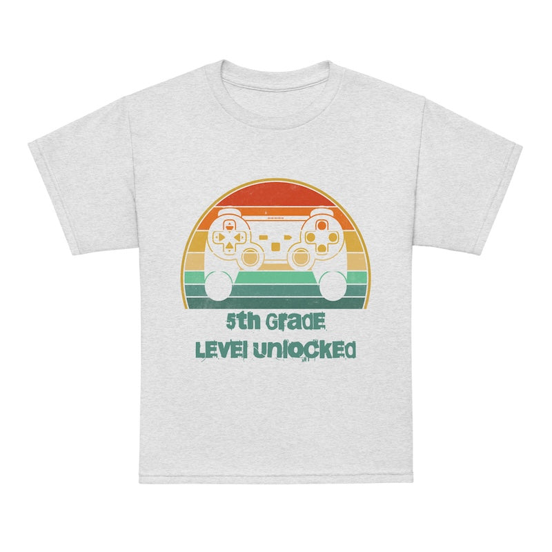 White t-shirt with retro game controller graphic and '5th Grade Level Unlocked' text on a white background
