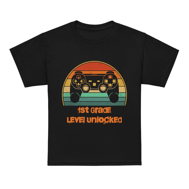 Black t-shirt with a colorful graphic and text '1st Grade Level Unlocked' on a white background