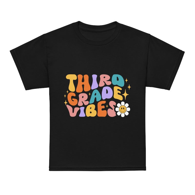 Black t-shirt with colorful 'Third Grade Vibes' text and a flower graphic on a white background