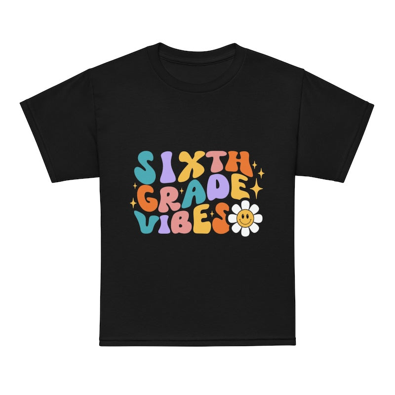 Black t-shirt with colorful 'Sixth Grade Vibes' text and a flower graphic on a white background