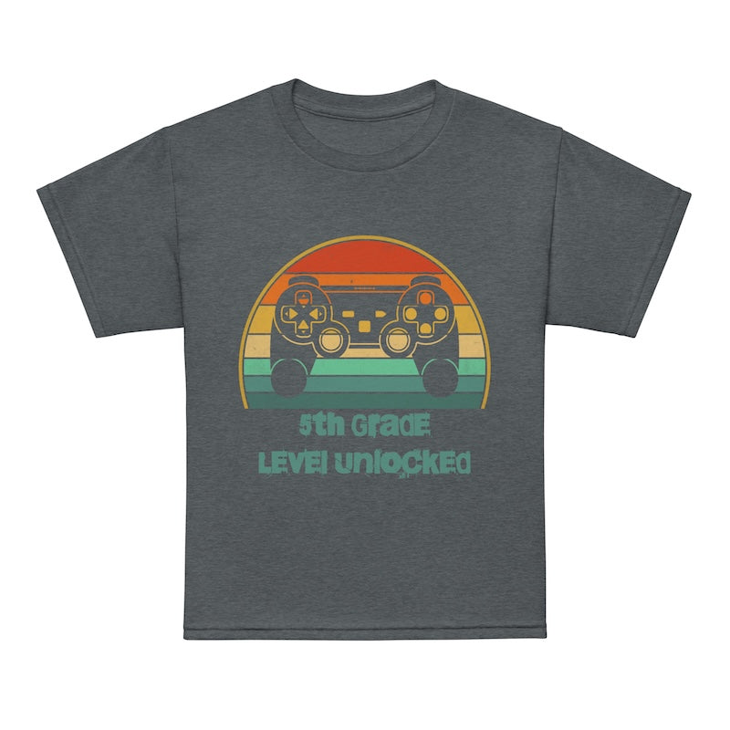 Gray t-shirt with a colorful graphic of game controllers and text on a white background